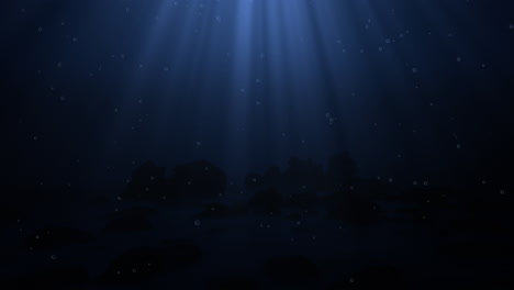 Dark-blue-ocean-bottom-with-bubbles-and-light-rays-deep-underwater