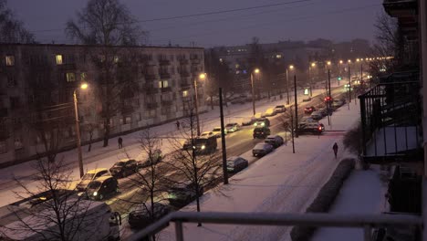 snowy city streets of riga, latvia during winter snowstorm blizzard at night