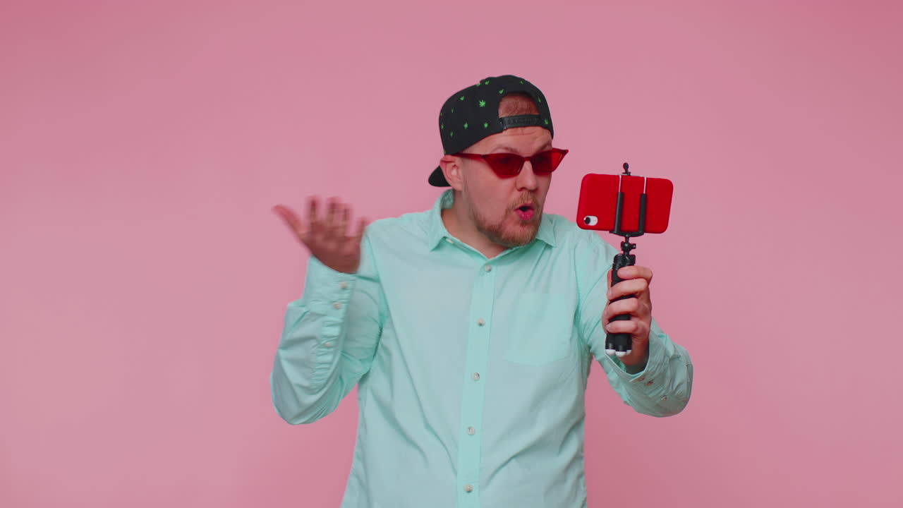 Man blogger take selfie on mobile phone selfie stick communicate video call online with subscribers