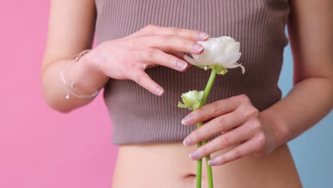 Beautiful-woman-holding-roses-in-blossoming-rose-garden-enjoying-natural-scent