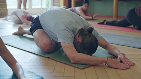 group yoga class practicing child's pose