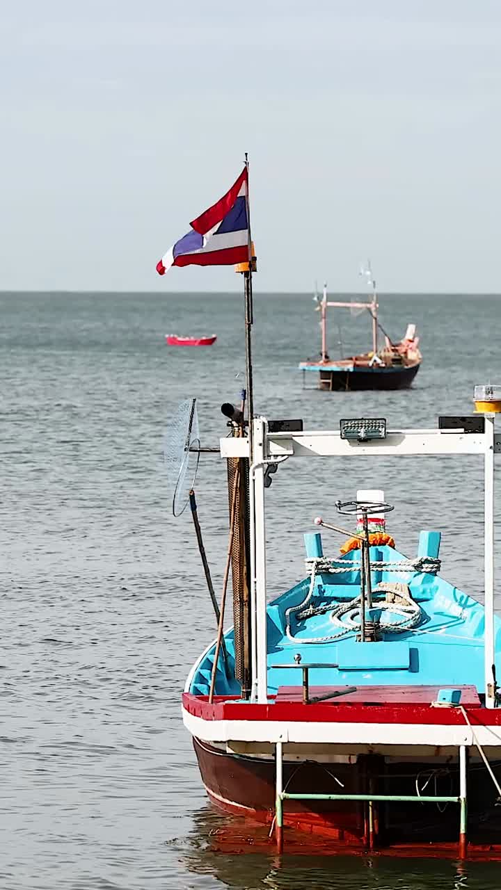 Boat anchored with Thai flag in Chonburi waters