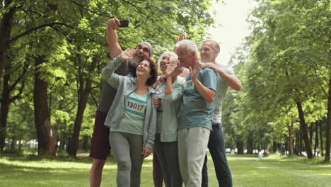 senior citizens taking a selfie in a park