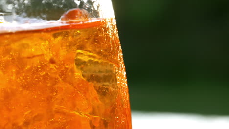 refreshing orange drink in the sun - 180fps