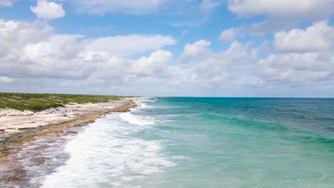 low establishing drone shot of the beautiful tropical beach coastline of cozumel mexico in 4k