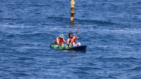 two people kayaking in sorrento, naples, italy