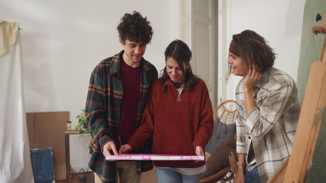 Friends Reviewing a Painting in a Home Studio