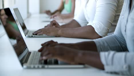 Cropped shot of young woman using laptop