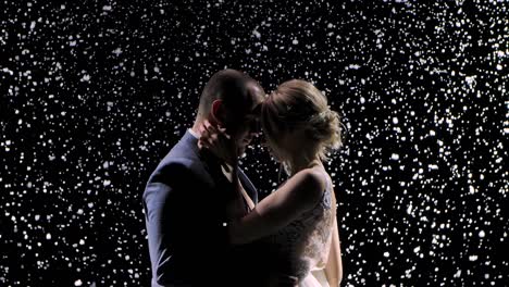 couple in love with snow falling around them