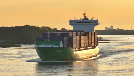 large cargo ship 'panda 003' sailing on a waterway at sunset