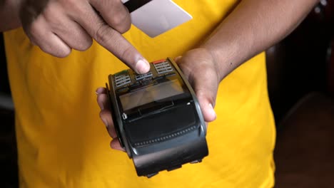 person using a pos terminal for payment