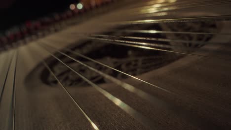 grand piano strings, no camera movement, closeup, slow motion, dark, yellow wood