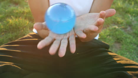 Female with glass juggling sphere