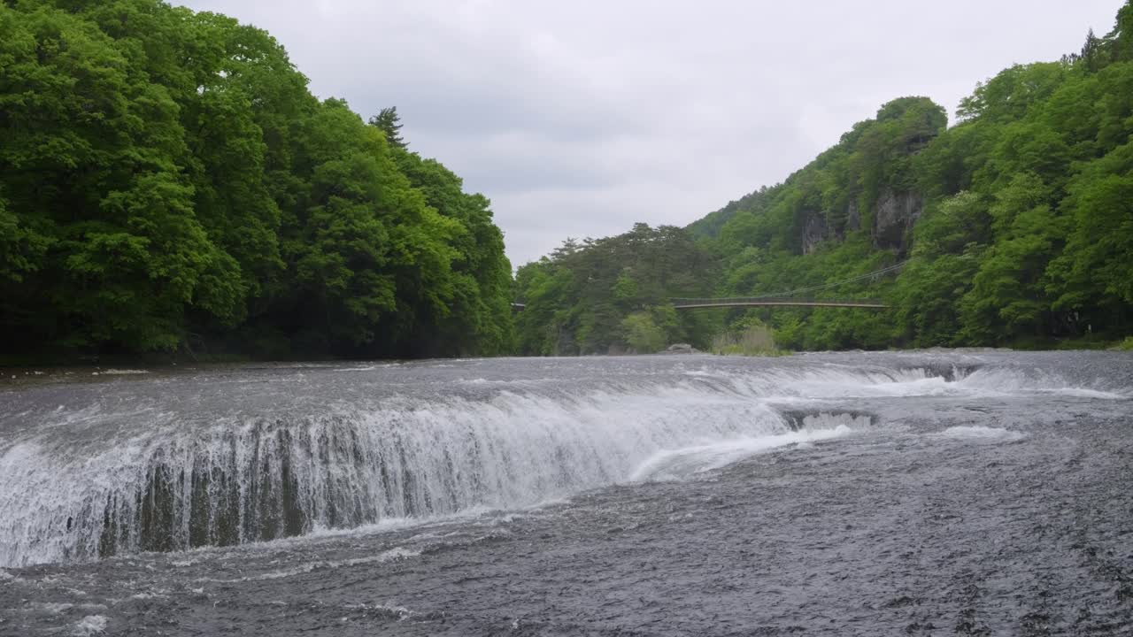Beautiful wide open cascading waterfalls on gloomy summer day