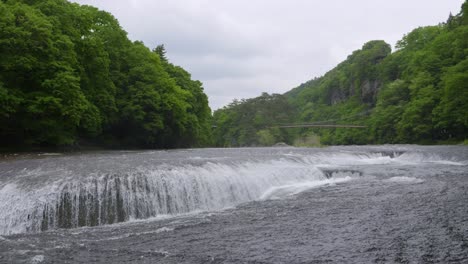 beautiful wide open cascading waterfalls on gloomy summer day