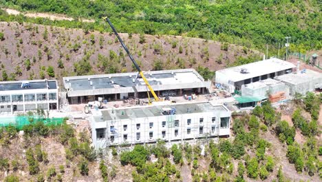 workers on the construction site in the mountains of busuanga island, palawan, philippines. aerial drone shot