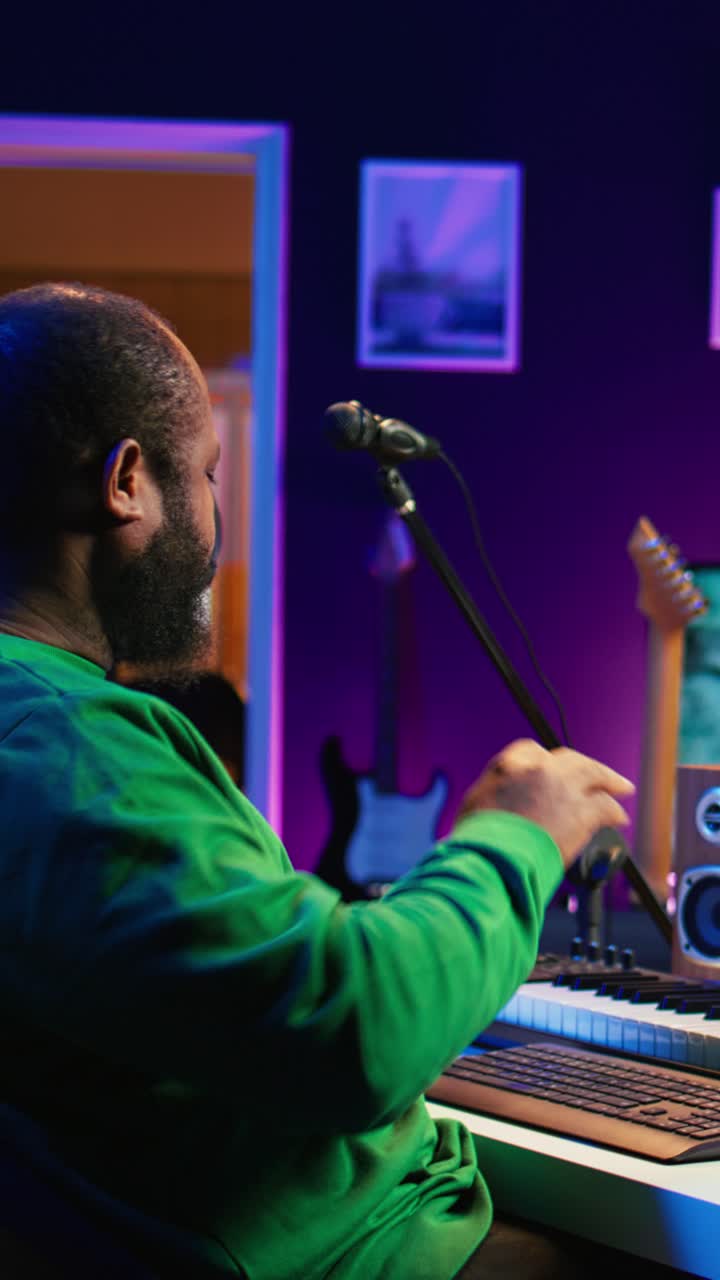 African American Man Playing MIDI Keyboard in Home Music Studio