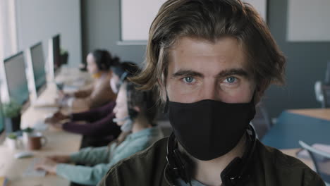 man wearing a mask in a call center office