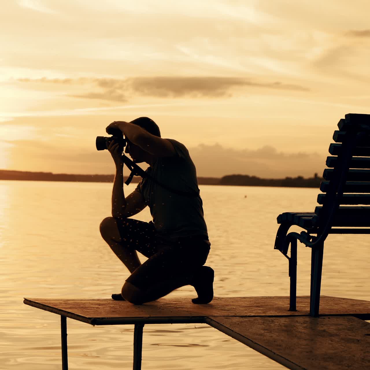Silhouette photographer on the golden beach during sunrise / sunset. Work on vacation