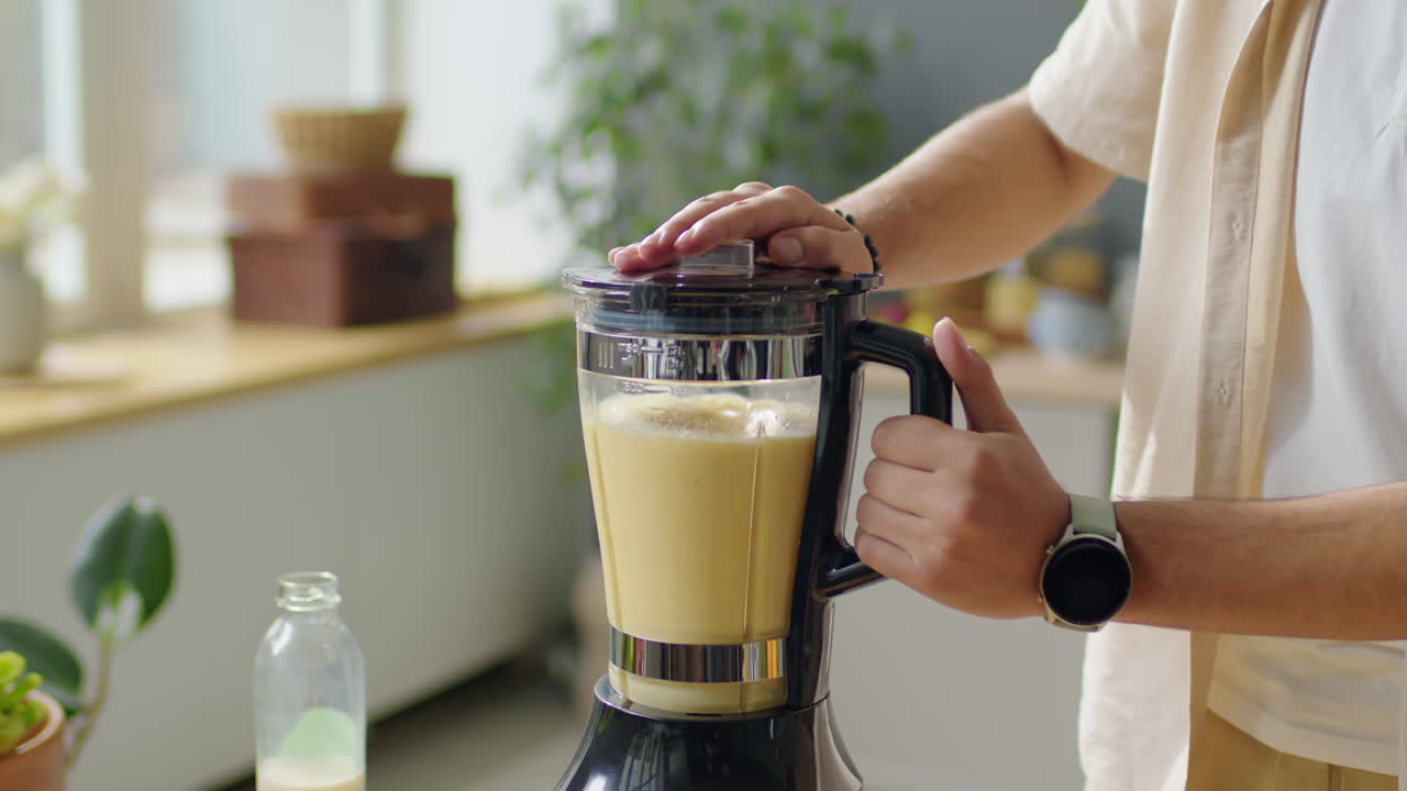 Man Preparing Fruit Smoothie in Blender