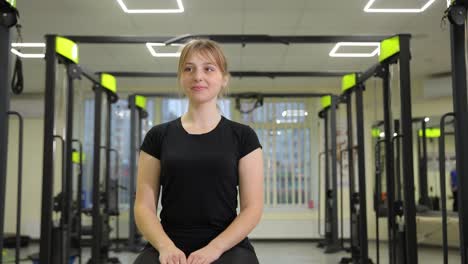 Woman seated in a gym