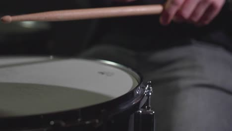 smooth close up of a shiny drum ride cymbal and a snare being played with sticks