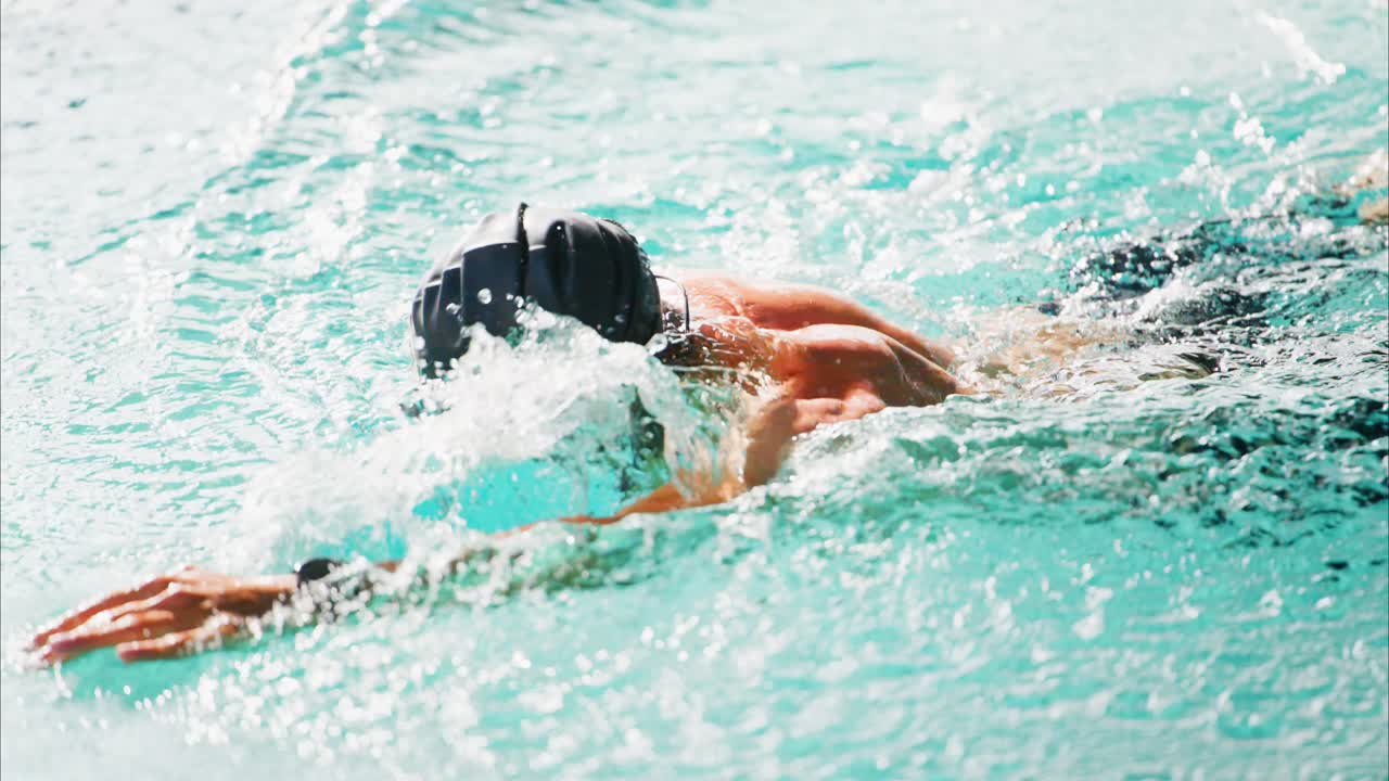 Dynamic Swimming Performance: A Competitive Swimmer Gliding Through Clear Water in a Pool, Showcasing Technique, Skill, and Athleticism in Action