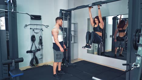 fitness training together. young woman exercise together with personal trainer in the gym