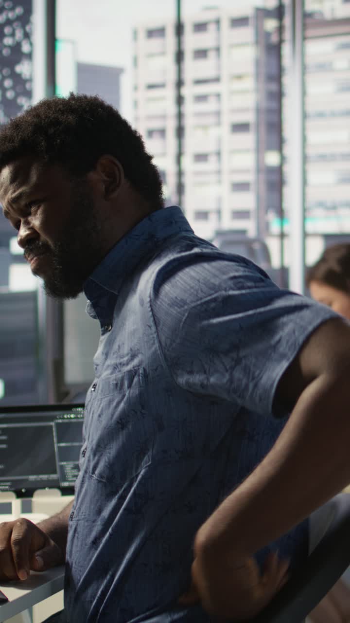 Vertical video Employee with grimace on face stretching to relieve muscle strain