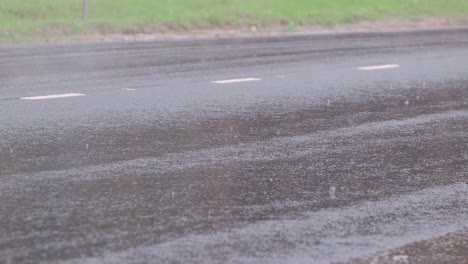 during the rain, the wheels of moving cars close-up.