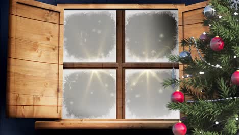 christmas tree and wooden window frame against golden spots of light on black background