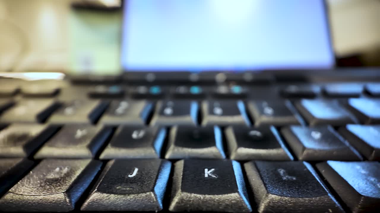 Old computer keyboard keys showing wear and tear from use, creating an aged tech aesthetic