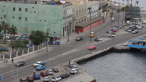 vintage antique convertible cars drive past down below in havana cuba