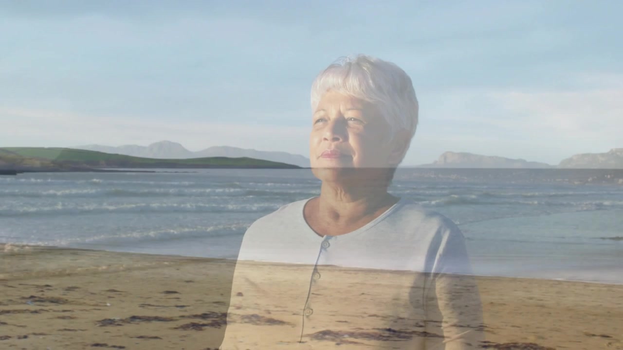 Senior woman breathing on shoreline health animation making fading veil solid while gazing horizon