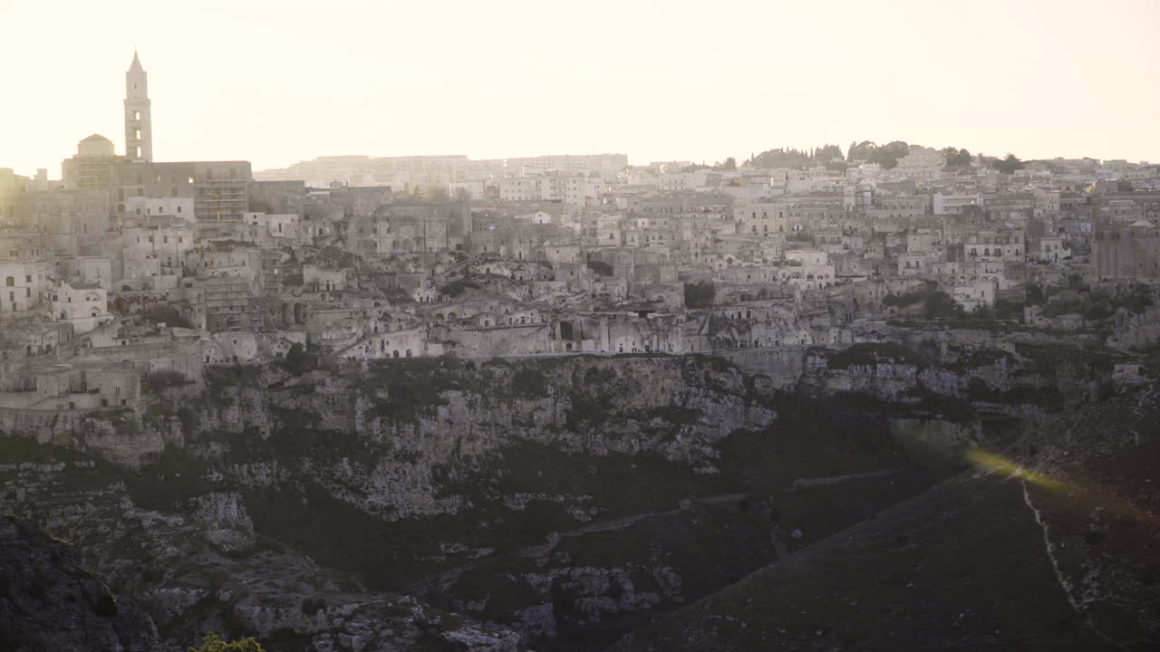 The view of the beautiful white peaceful city of Matera, Italy during sunset - wide pan