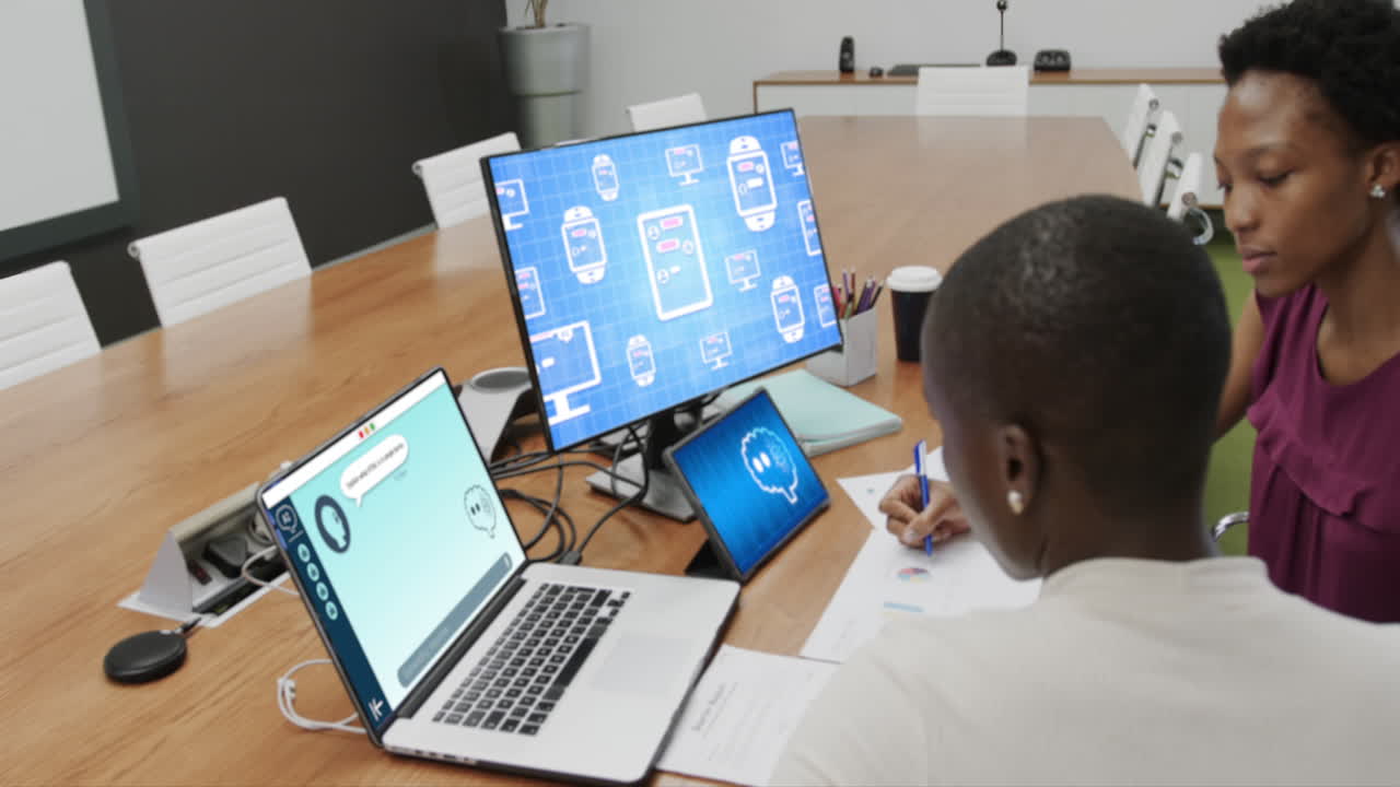 Diverse businesswomen in office using computer with ai interface and messaging on screen