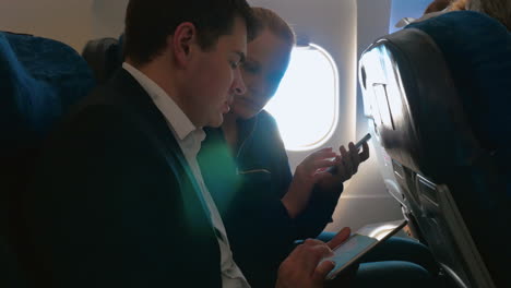 man and woman talking on business using pad