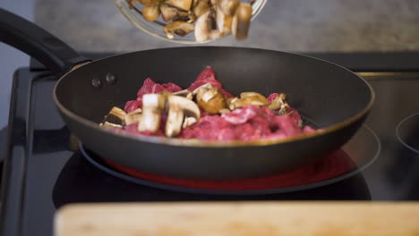 mushrooms falling onto a cuttingboard