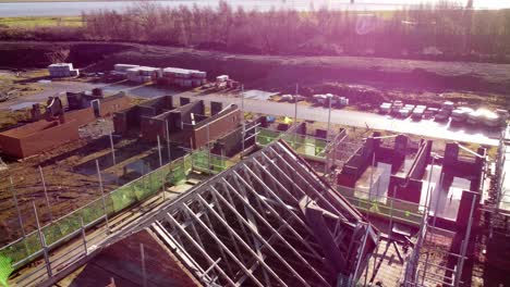 unfinished waterfront townhouse scaffolding framework on builders development construction site aerial view