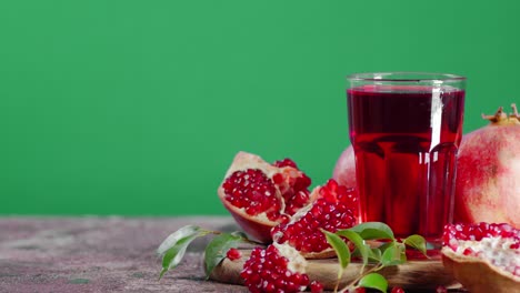 pomegranate juice in glass on cutting board rotates slowly.