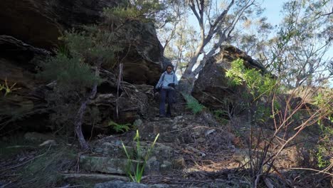 Indigenous-Australian-girl-walking-down-steep-stairs-in-the-Blue-Mountains-National-park,-NSW-Australia