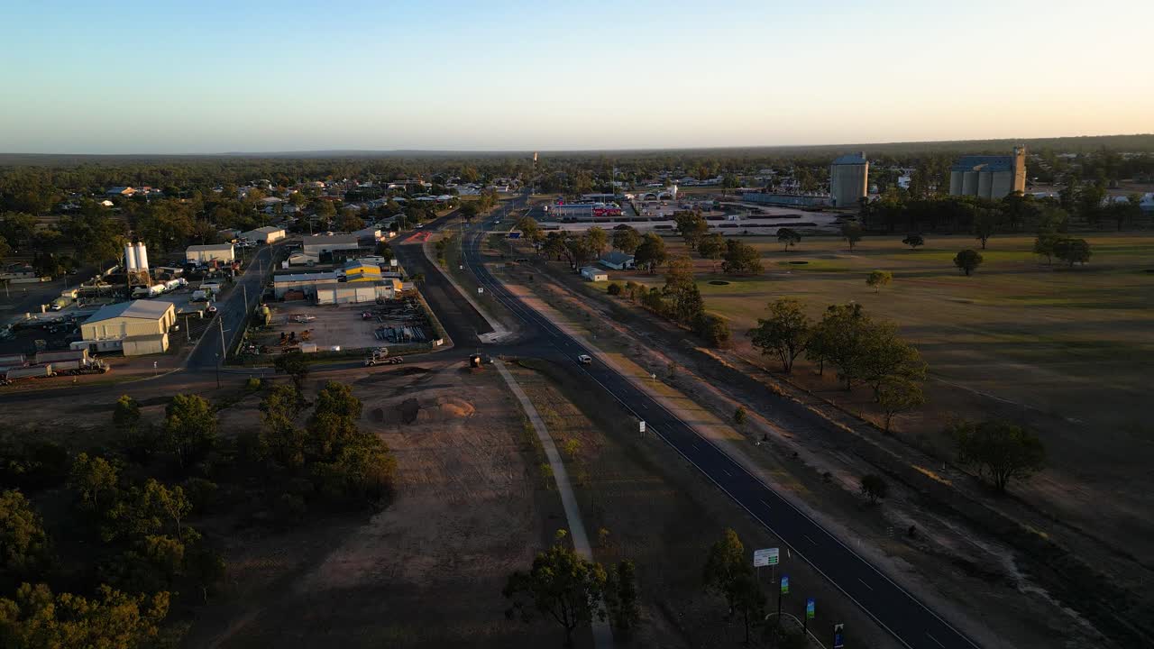 Vertical aerial rise at sunrise over an industrial area at Miles Queensland.