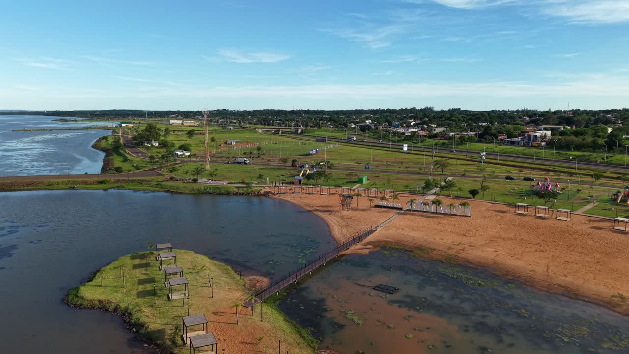 Aerial view of Posadas beach, vibrant summer day at Balneario Costa Sur