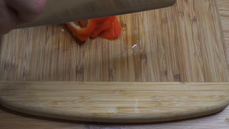 slicing red pepper with cleaver, dolly shot forward and over