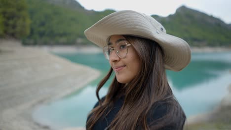 woman taking a selfie by a beautiful lake