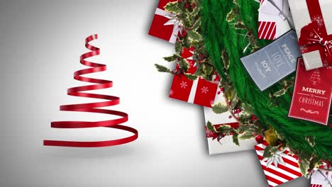 digital animation of ribbon forming a christmas tree and christmas gifts and cards