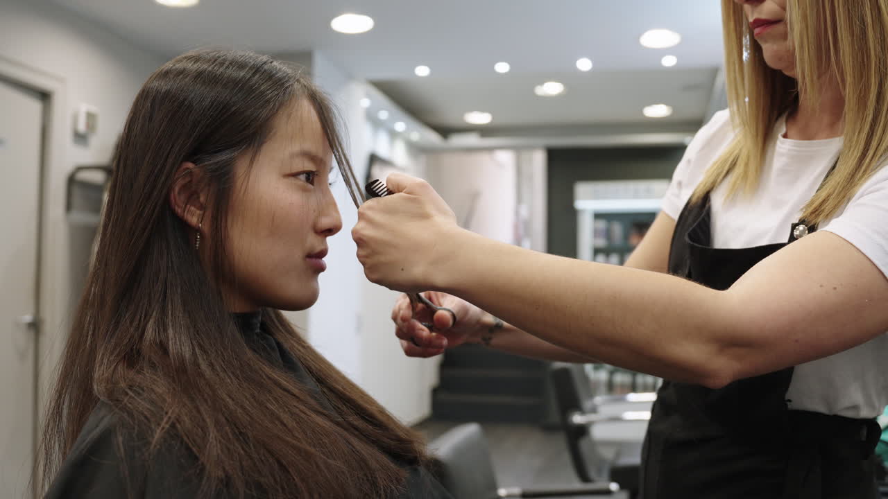 A woman gets a haircut at a hair salon