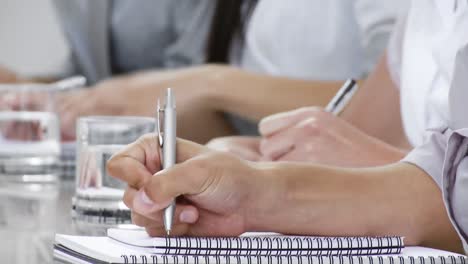 Close-up-of-hands-writing-notes