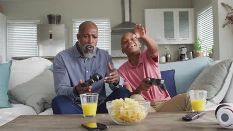 Video-of-happy-african-american-father-and-son-playing-video-games