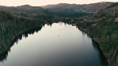 still water of a lake with mirror reflection during sunset